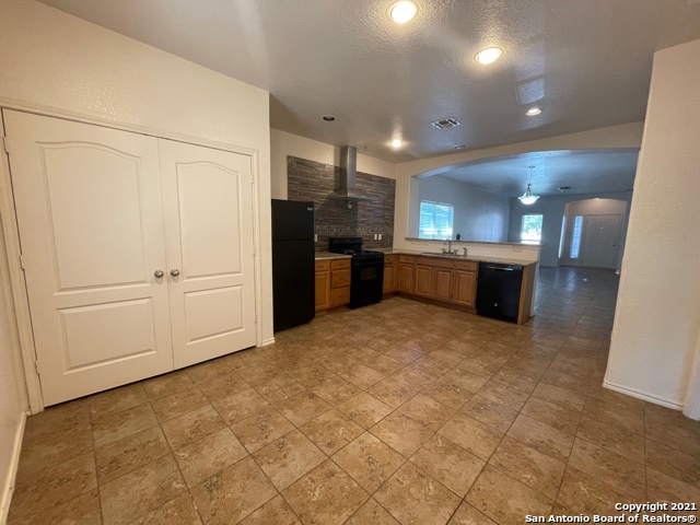 434 Tequila Ranch San Antonio, TX 78245 - Photo 5 of 21 a large kitchen with a refrigerator and a stove
