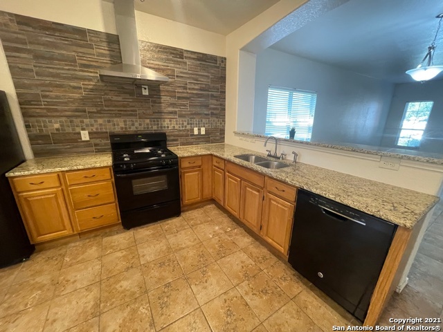 434 Tequila Ranch San Antonio, TX 78245 - Photo 7 of 21 a kitchen with stainless steel appliances granite countertop a stove sink and cabinets