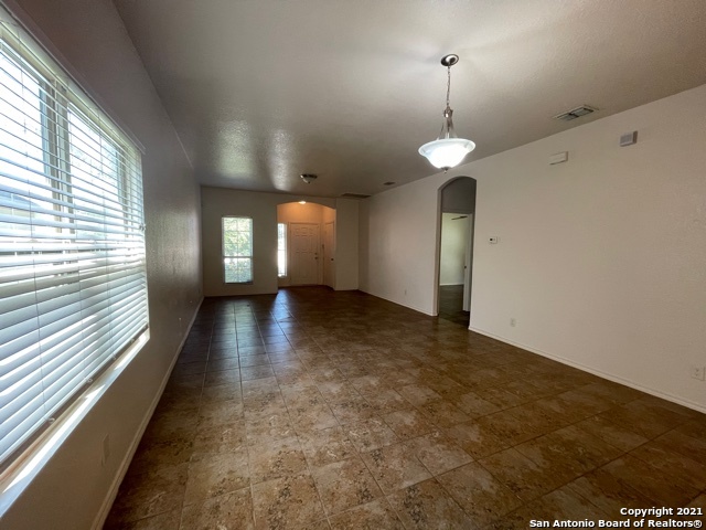 434 Tequila Ranch San Antonio, TX 78245 - Photo 8 of 21 wooden floor in an empty room with a window