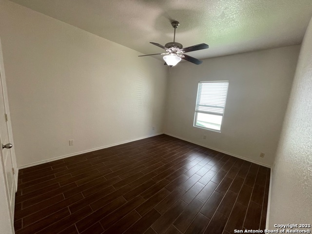 434 Tequila Ranch San Antonio, TX 78245 - Photo 10 of 21 an empty room with wooden floor fan and windows