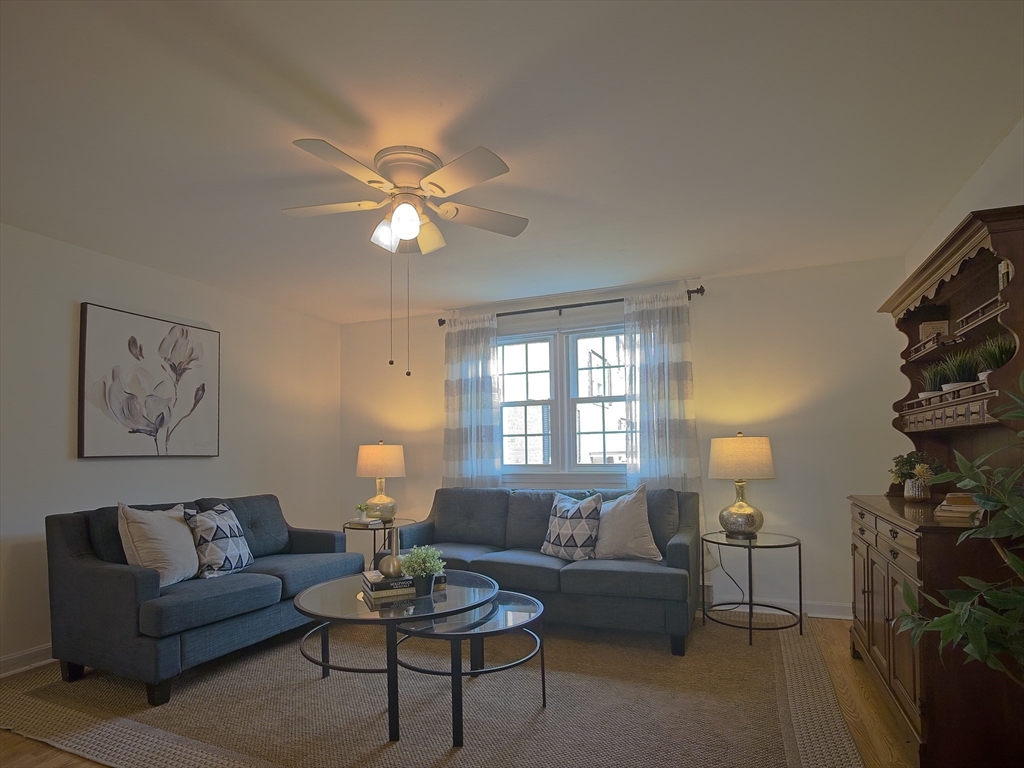 57 Sylvan Street, Unit 5D Danvers, MA 01923 - Photo 1 of 15 a living room with furniture a lamp and a window