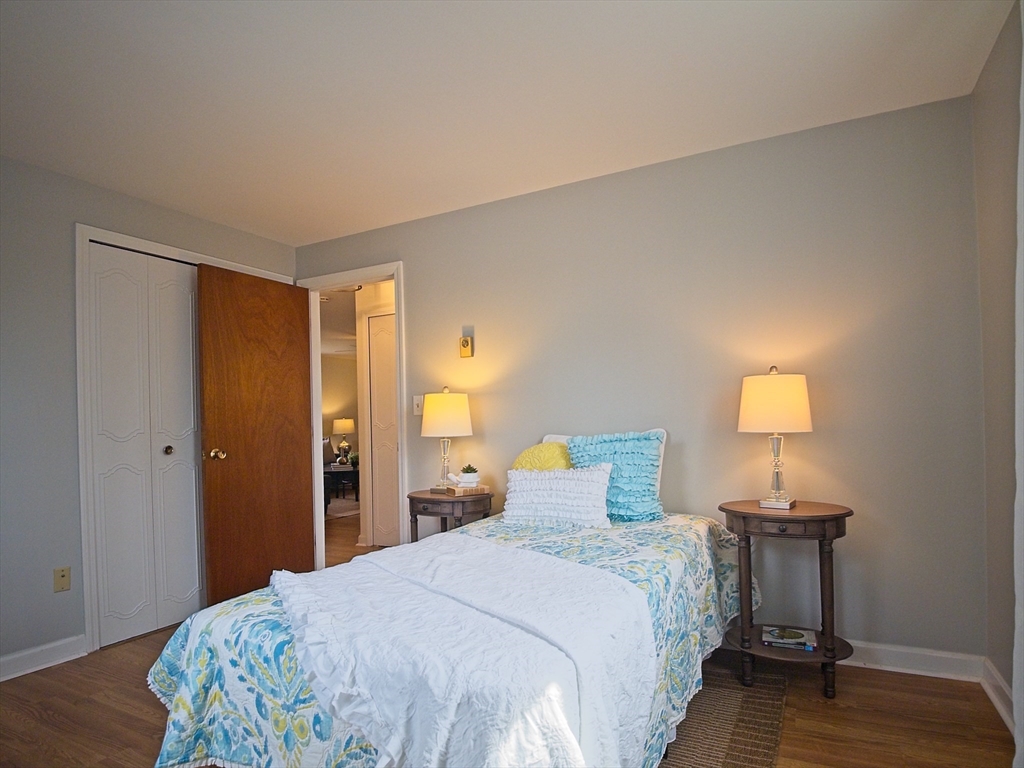 57 Sylvan Street, Unit 5D Danvers, MA 01923 - Photo 11 of 15 a bedroom with a bed and wooden floor