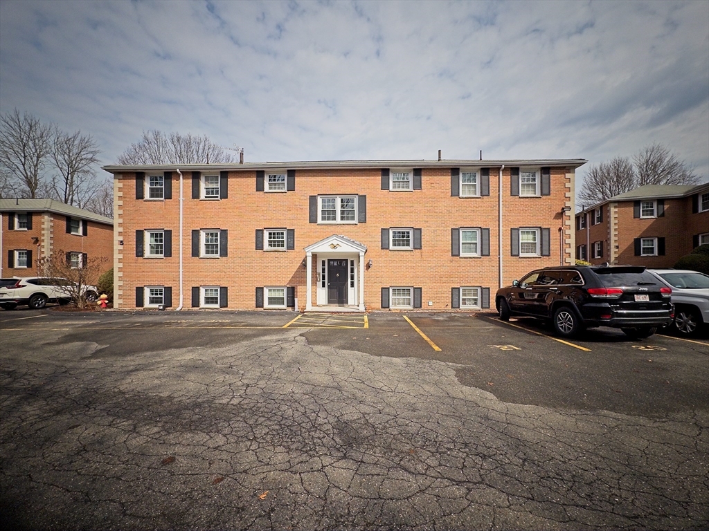 57 Sylvan Street, Unit 5D Danvers, MA 01923 - Photo 15 of 15 a couple of cars parked in front of a building