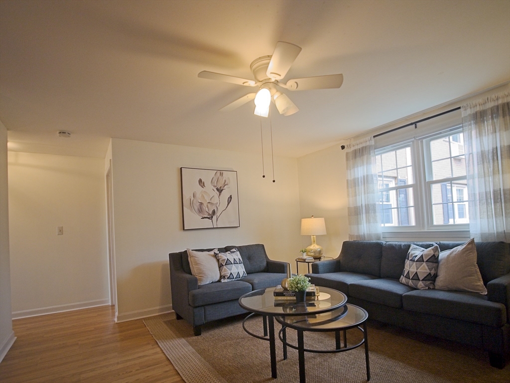 57 Sylvan Street, Unit 5D Danvers, MA 01923 - Photo 3 of 15 a living room with furniture and a large window