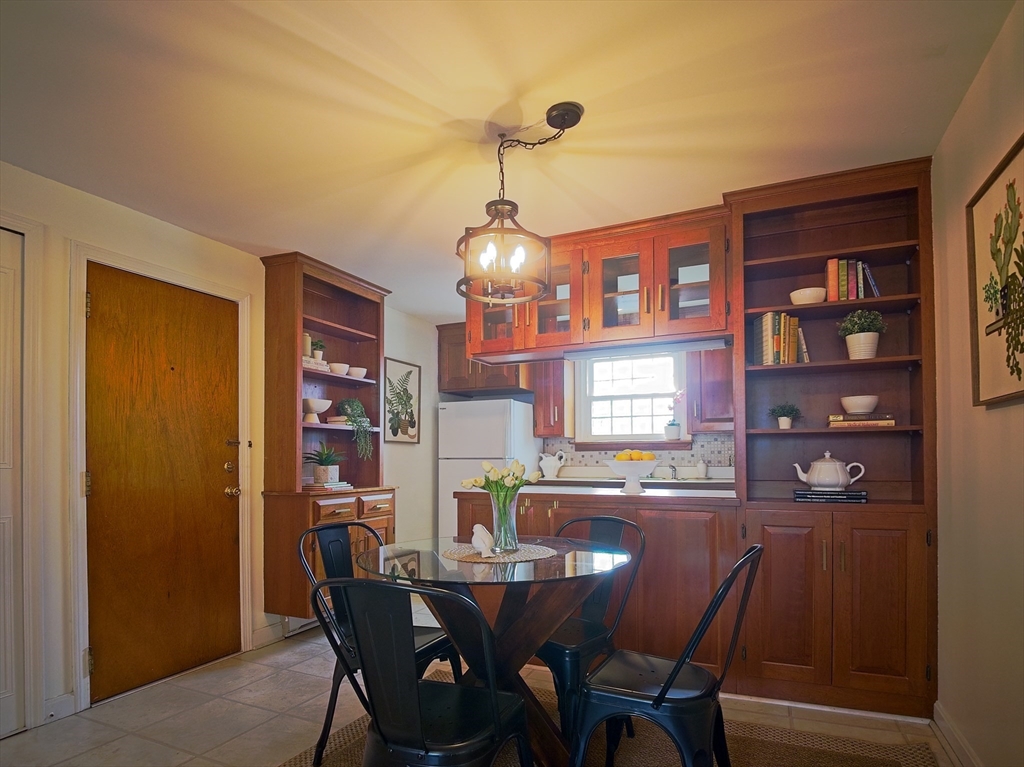 57 Sylvan Street, Unit 5D Danvers, MA 01923 - Photo 4 of 15 a dining room with furniture and window