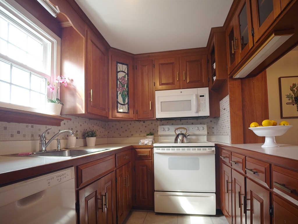 57 Sylvan Street, Unit 5D Danvers, MA 01923 - Photo 7 of 15 a kitchen with a sink and a cabinets
