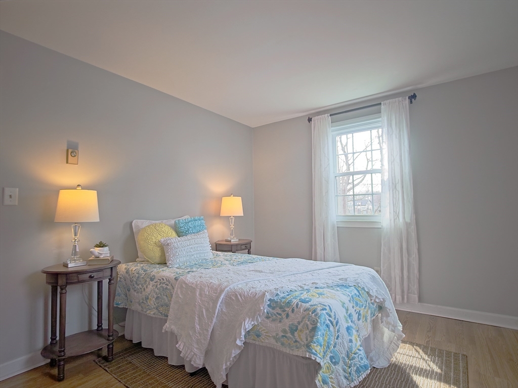 57 Sylvan Street, Unit 5D Danvers, MA 01923 - Photo 10 of 15 a bedroom with a bed and a lamp