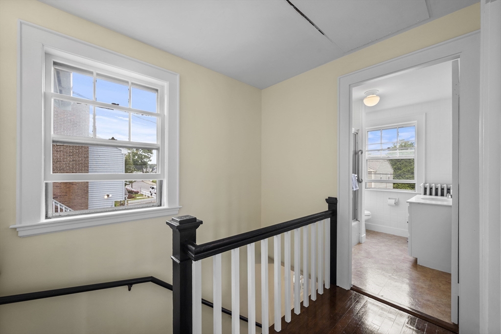 12 Riverside Avenue Gloucester, MA 01930 - Photo 20 of 40 a view of hallway with a window and wooden floor