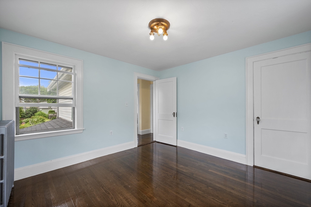12 Riverside Avenue Gloucester, MA 01930 - Photo 28 of 40 a view of an empty room with wooden floor and a window