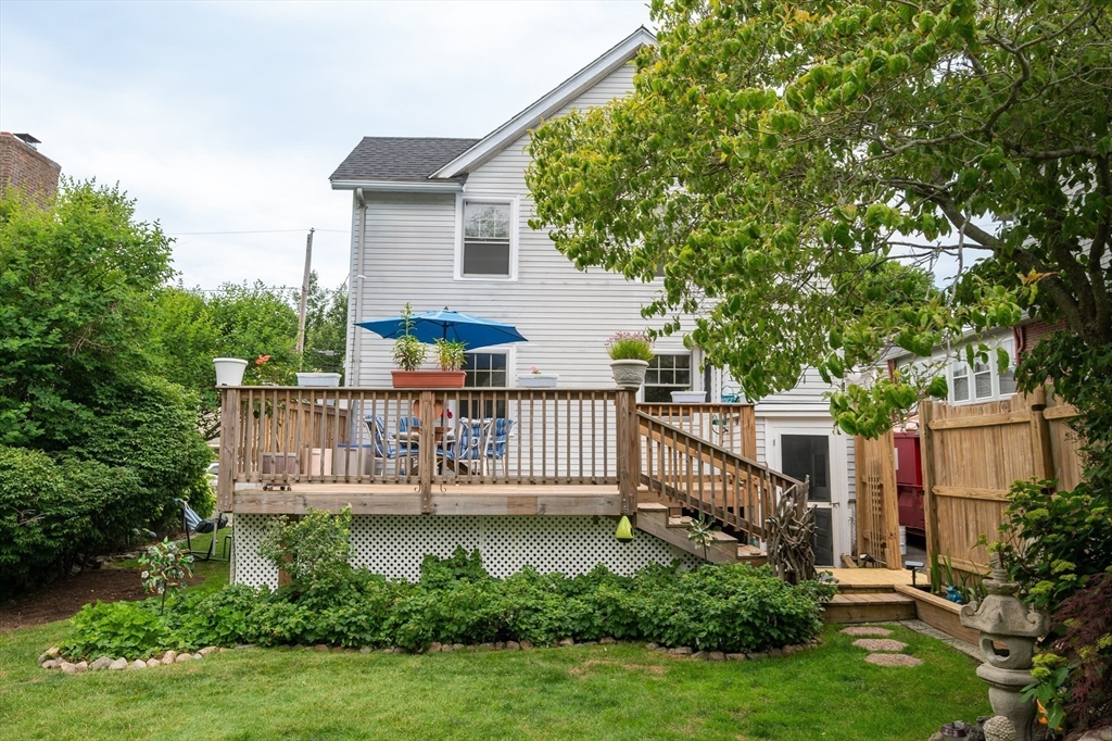12 Riverside Avenue Gloucester, MA 01930 - Photo 5 of 40 a balcony with potted plants and a large tree