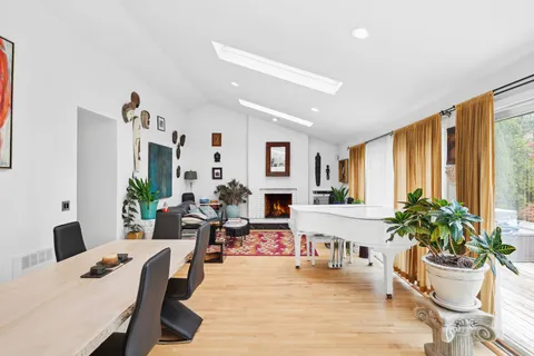 a living room with furniture potted plant and a large window