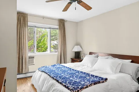 a bedroom with a large bed and a window