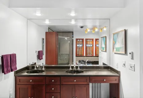 a bathroom with a double vanity sink and a mirror