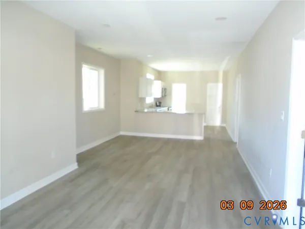 an empty room with windows and entrance