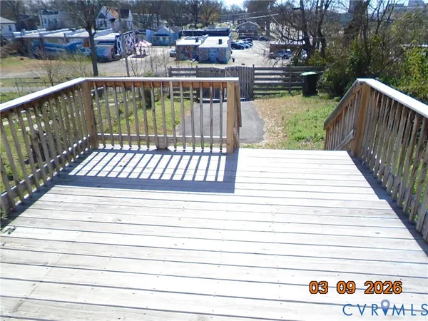 a view of a balcony with wooden floor