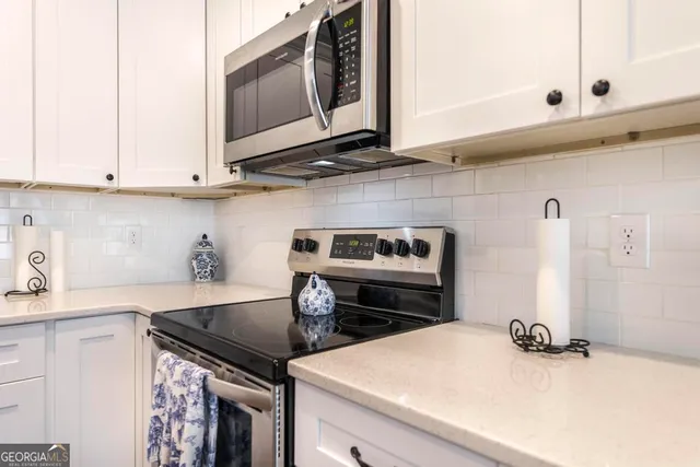 a kitchen with a stove and a microwave