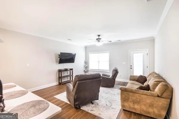 a living room with furniture and a flat screen tv
