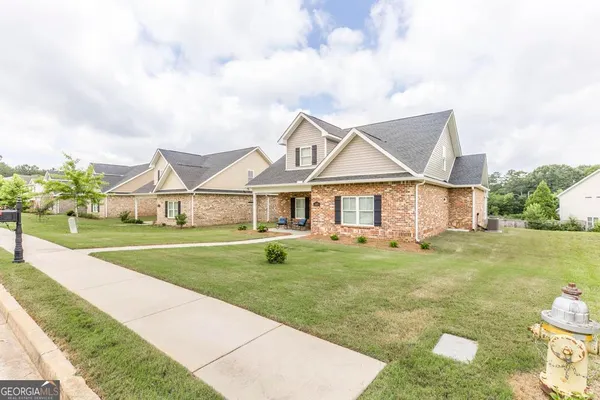 a front view of a house with garden