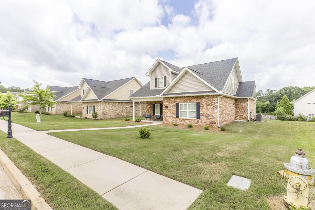 309 Charles Gray Boulevard Perry, GA 31069 - Photo 2 of 30 a front view of a house with garden