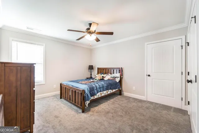 a bedroom with a bed closet and a window