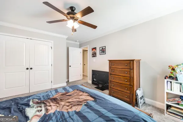 a bedroom with a bed and a television