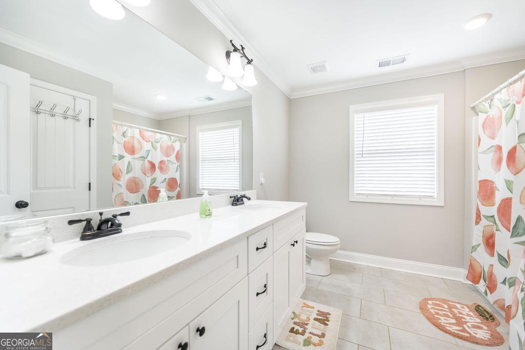 309 Charles Gray Boulevard Perry, GA 31069 - Photo 25 of 30 a bathroom with a sink a toilet and a mirror
