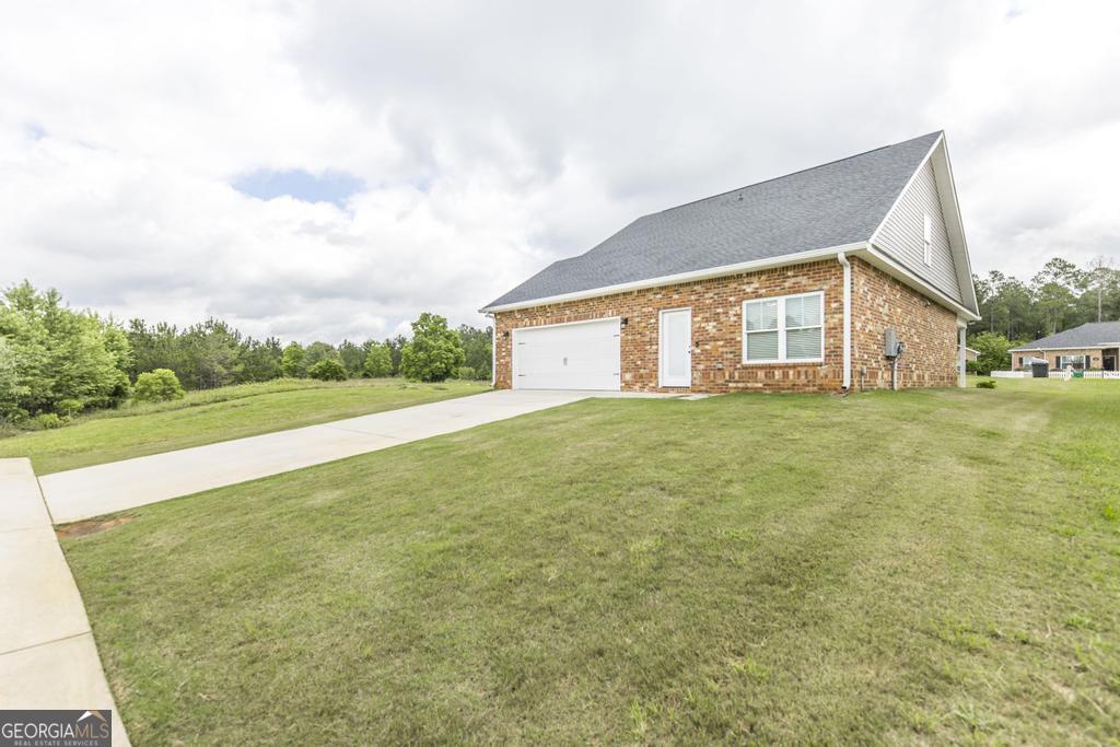 309 Charles Gray Boulevard Perry, GA 31069 - Photo 30 of 30 a view of a house with a big yard and large trees