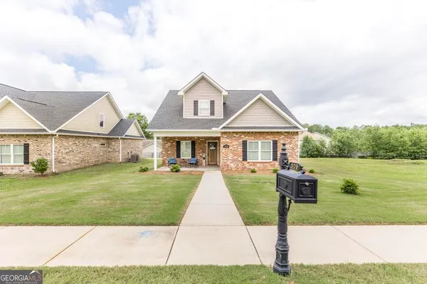 a front view of house with yard and green space