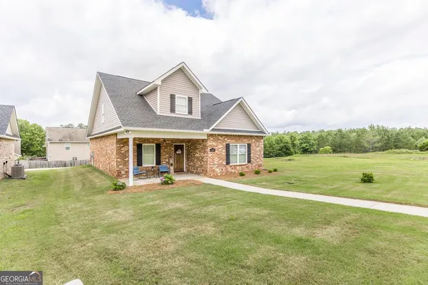 a front view of a house with garden