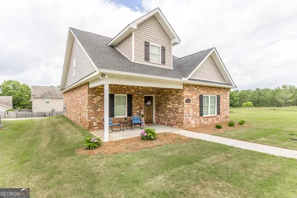 a front view of a house with garden