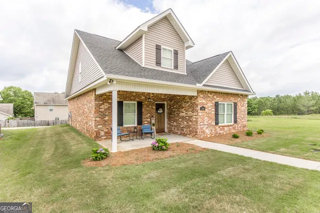 a front view of a house with garden