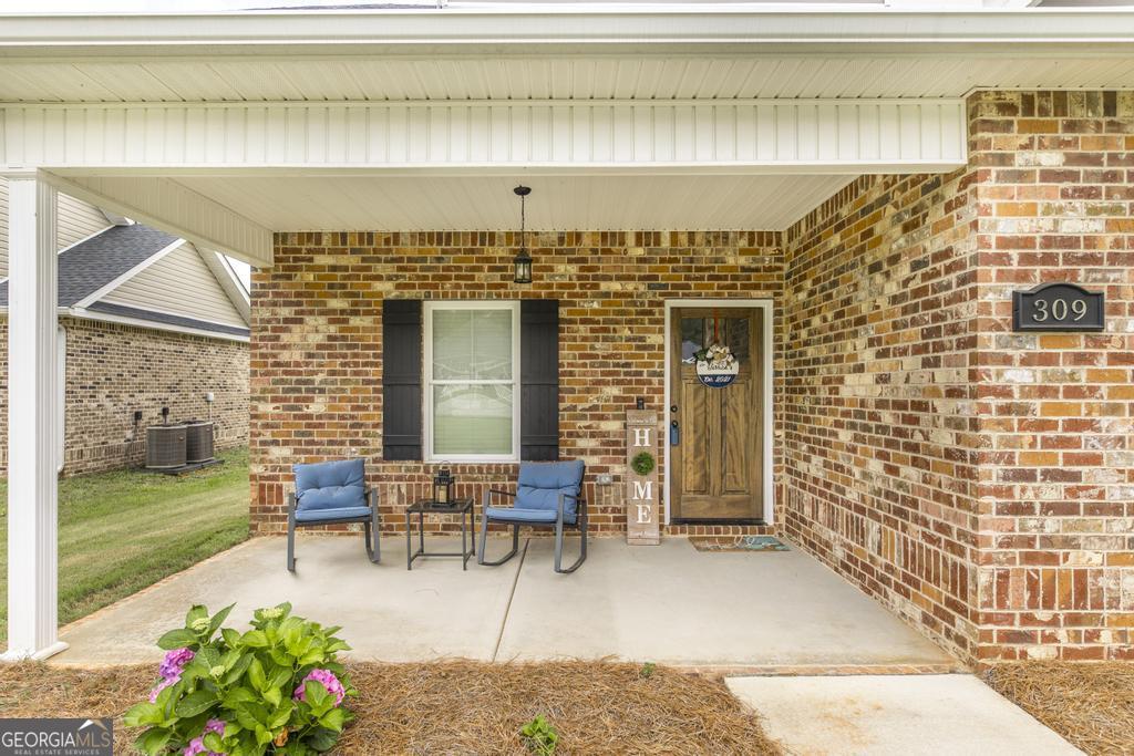 309 Charles Gray Boulevard Perry, GA 31069 - Photo 6 of 30 a balcony with furniture and a potted plant