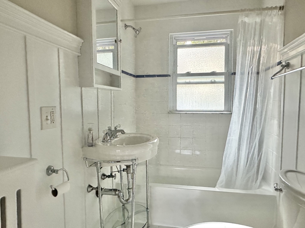8 A Mellon Road Wellesley, MA 02482 - Photo 15 of 22 a bathroom with a sink a mirror and a shower