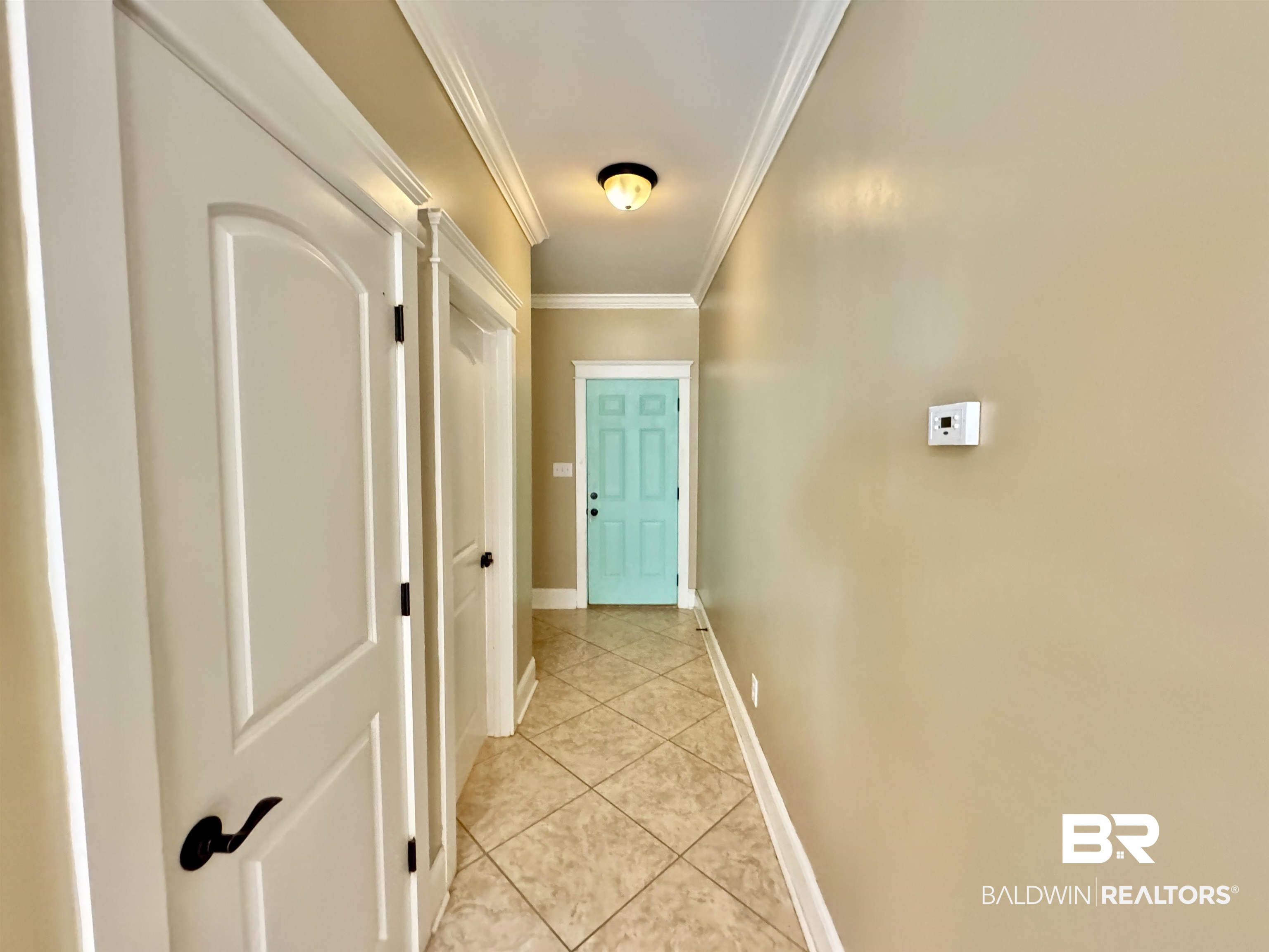 10846 County Road 138 Bay Minette, AL 36507 - Photo 49 of 53 Corridor with crown molding and light tile patterned flooring