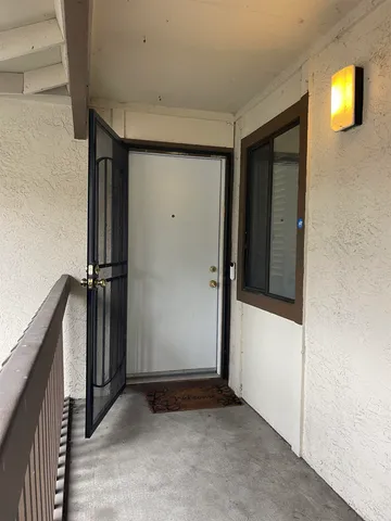an entryway door with a hallway in the house