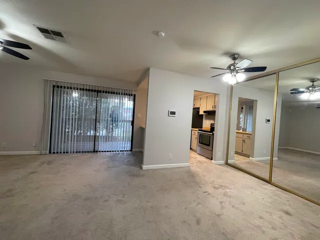 an empty room with fan and door