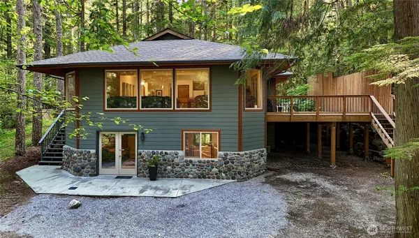 a front view of a house with plants