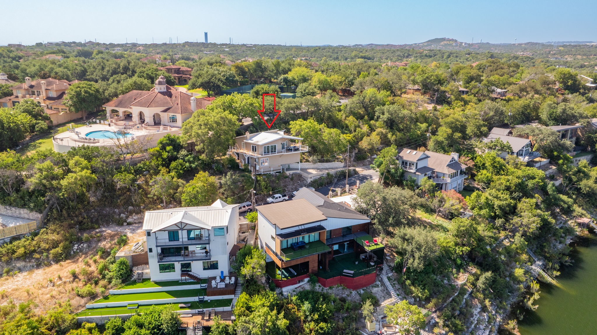 1715 Buffalo Gap Road Austin, TX 78734 - Photo 17 of 18 An elevated perspective showcases multi-level homes nestled along the sloping lakeside terrain.