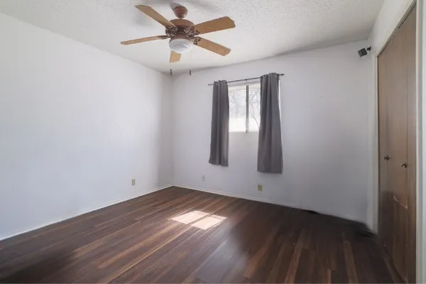 a bed room with a bed and a large window