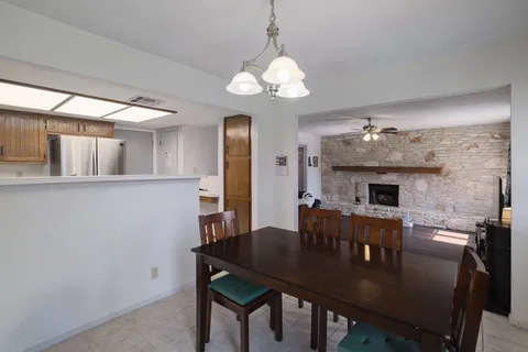 a view of a dining room with furniture and a chandelier