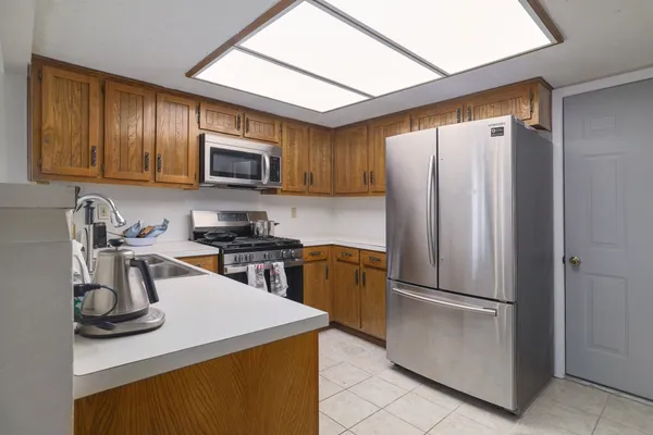 a kitchen with a refrigerator sink and microwave