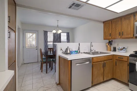 a kitchen with a sink stove and cabinets