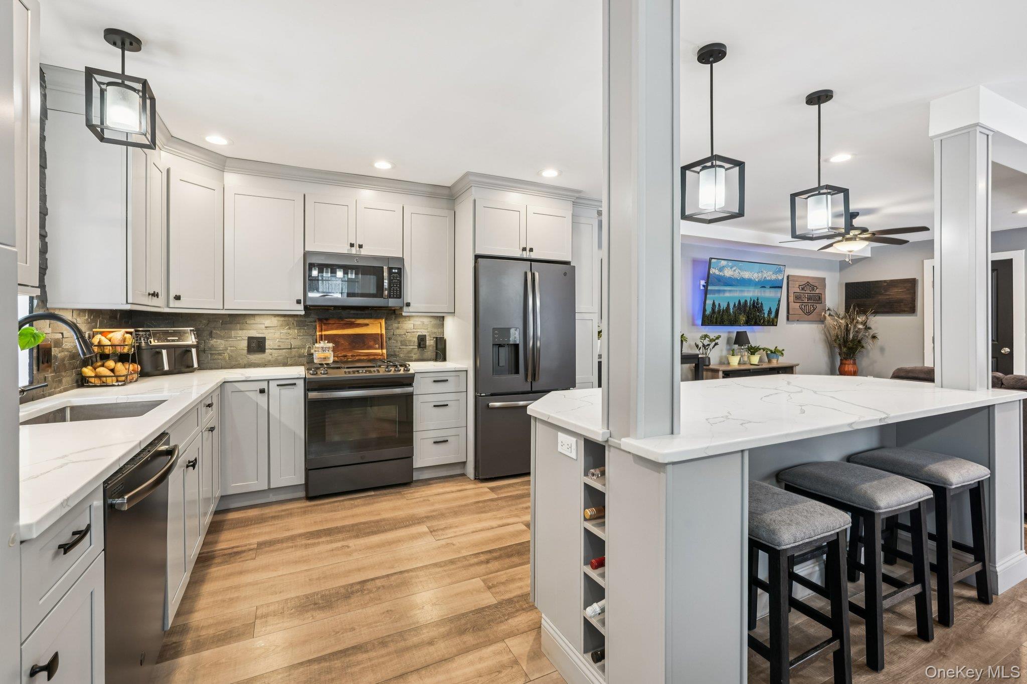 184 Quaker Street Wallkill, NY 12589 - Photo 12 of 35 a kitchen with kitchen island granite countertop wooden cabinets and white appliances
