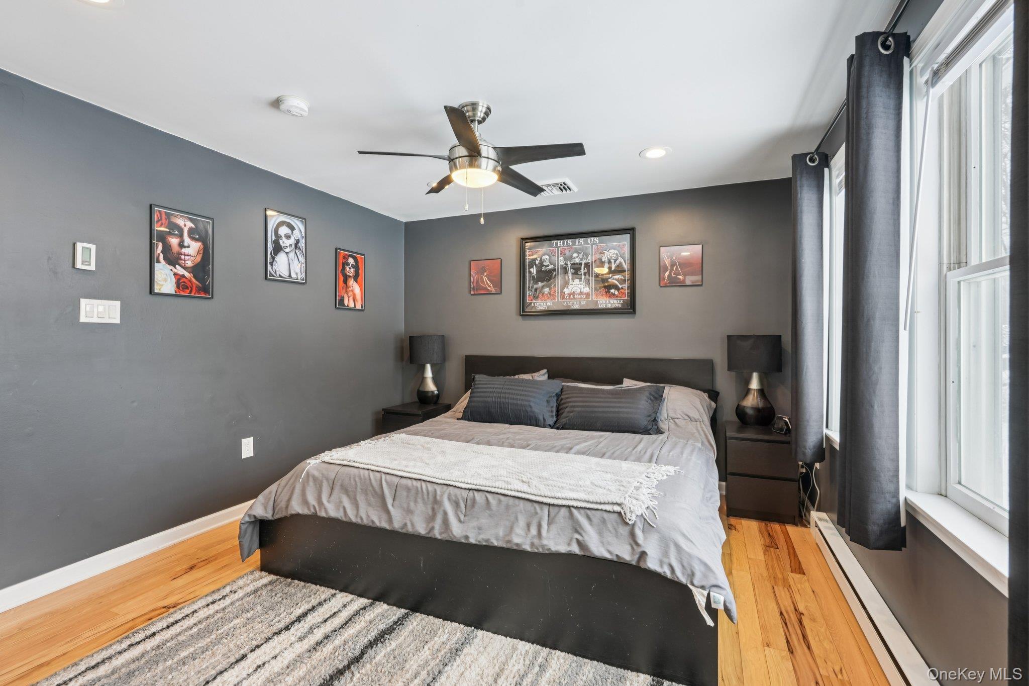 184 Quaker Street Wallkill, NY 12589 - Photo 16 of 35 a bedroom with a large bed and a chandelier