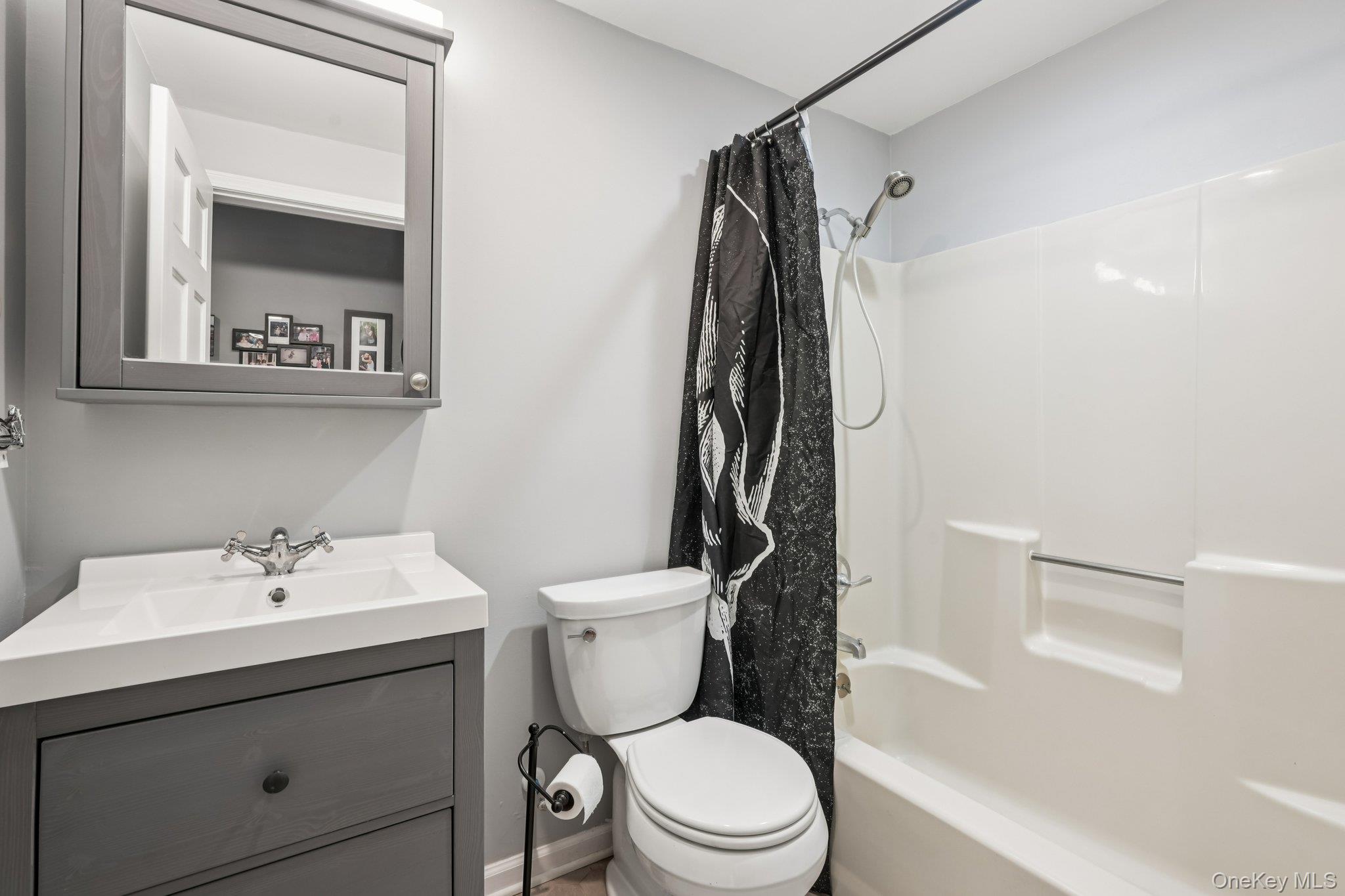 184 Quaker Street Wallkill, NY 12589 - Photo 27 of 35 a bathroom with a sink mirror vanity and toilet