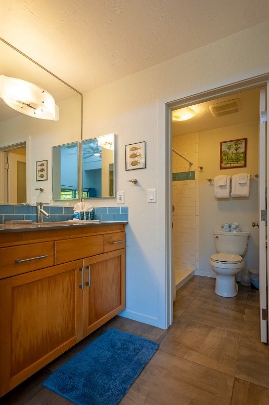 3880 Wyllie Road, Unit 1A Princeville, HI 96722 - Photo 11 of 22 a spacious bathroom with a granite countertop sink and a mirror