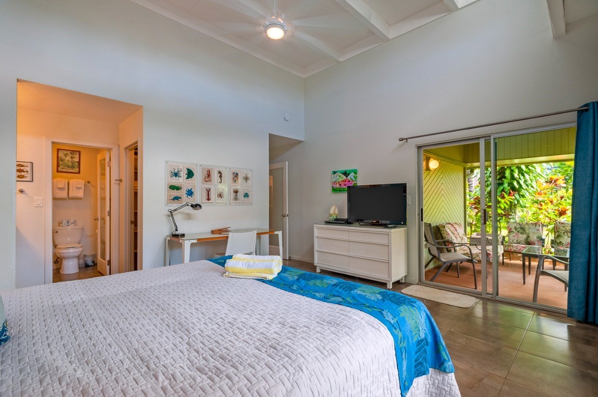 3880 Wyllie Road, Unit 1A Princeville, HI 96722 - Photo 2 of 22 a bedroom with a bed and large windows