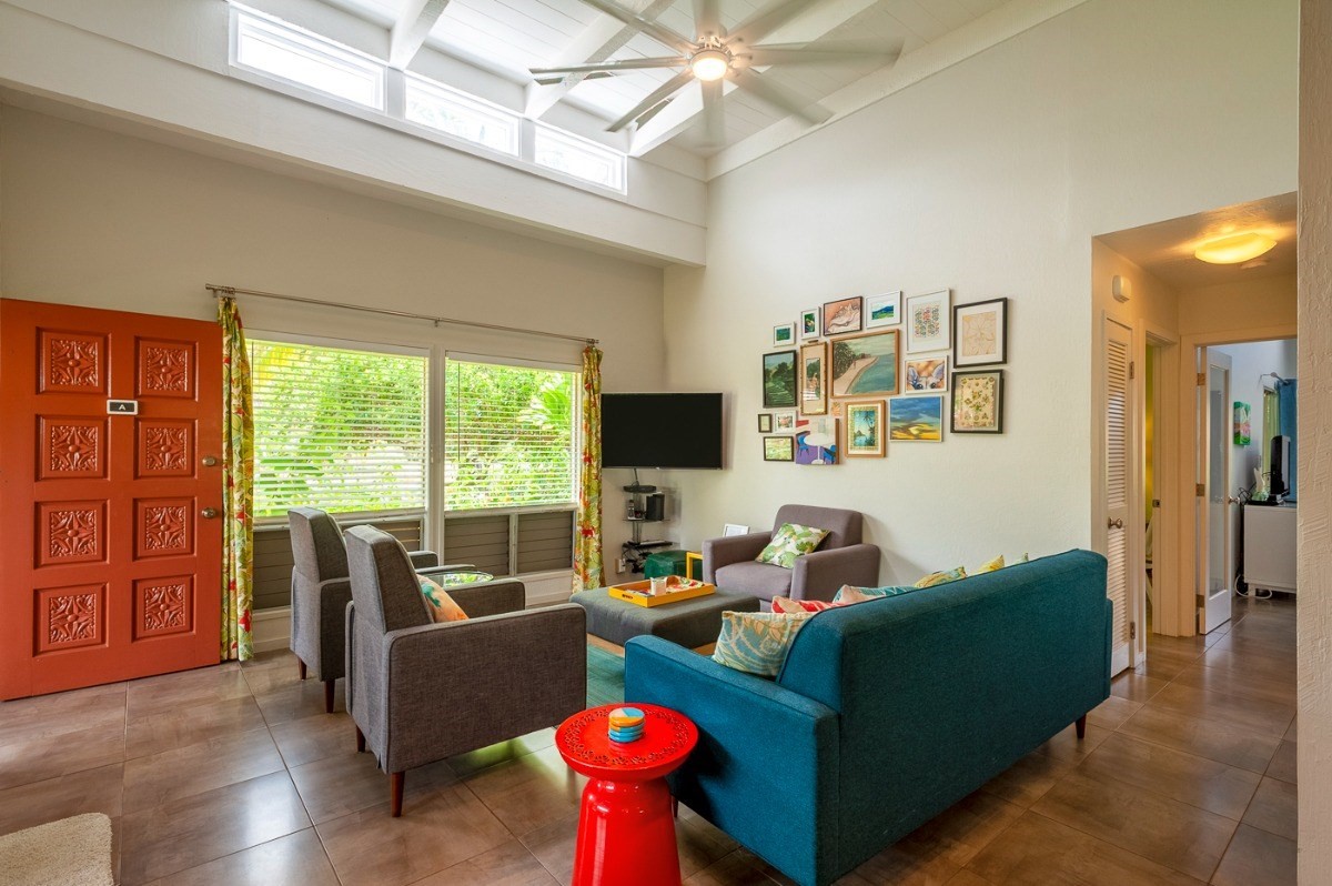 3880 Wyllie Road, Unit 1A Princeville, HI 96722 - Photo 3 of 22 a living room with furniture and a flat screen tv