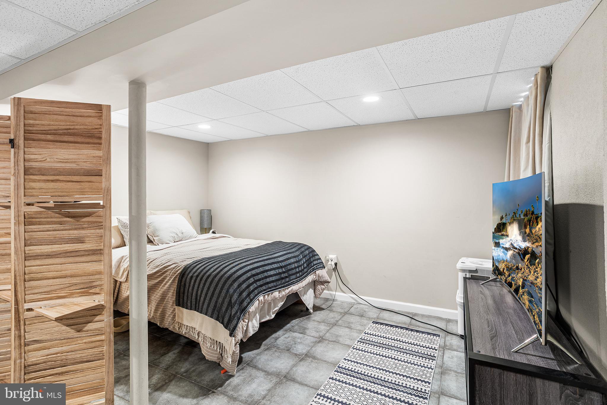 48 Falmouth Road Hamilton, NJ 08620 - Photo 27 of 34 a bedroom with a bed and a flat tv screen