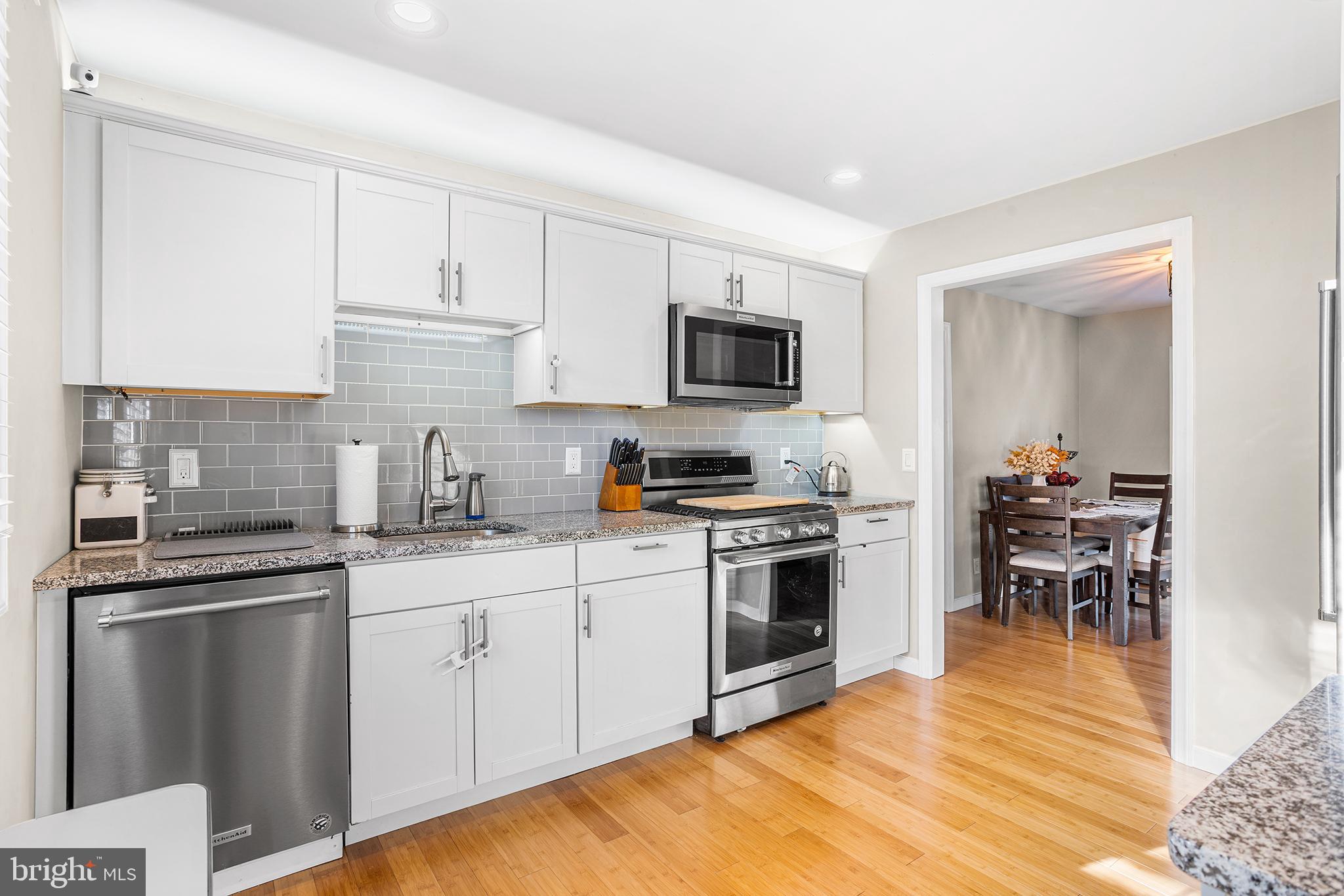 48 Falmouth Road Hamilton, NJ 08620 - Photo 7 of 34 a kitchen with cabinets stainless steel appliances and wooden floor